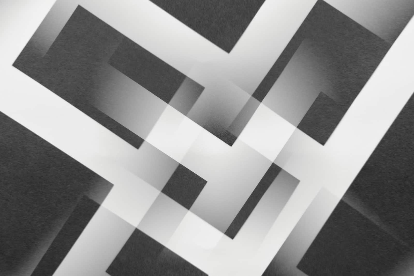 Minimalist abstract pattern with overlapping geometric shapes in black and white.